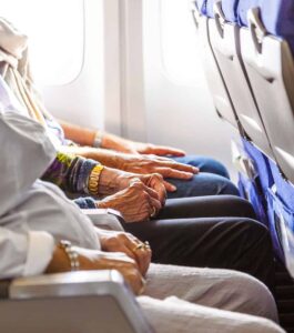 hand of an elderly lady sitting in the aircraft