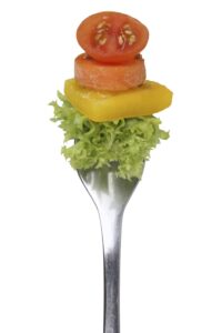 Vegetarian, veggie or vegan eating salad with fork isolated