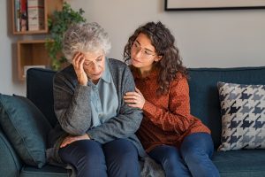 caregiver responding with love to frustrated senior adult