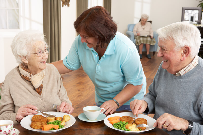 Senior Woman at Memory Care Facility Enjoying Breakfast