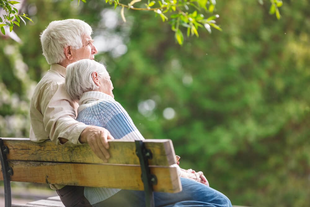 Senior Couple Sitting on Park Bench